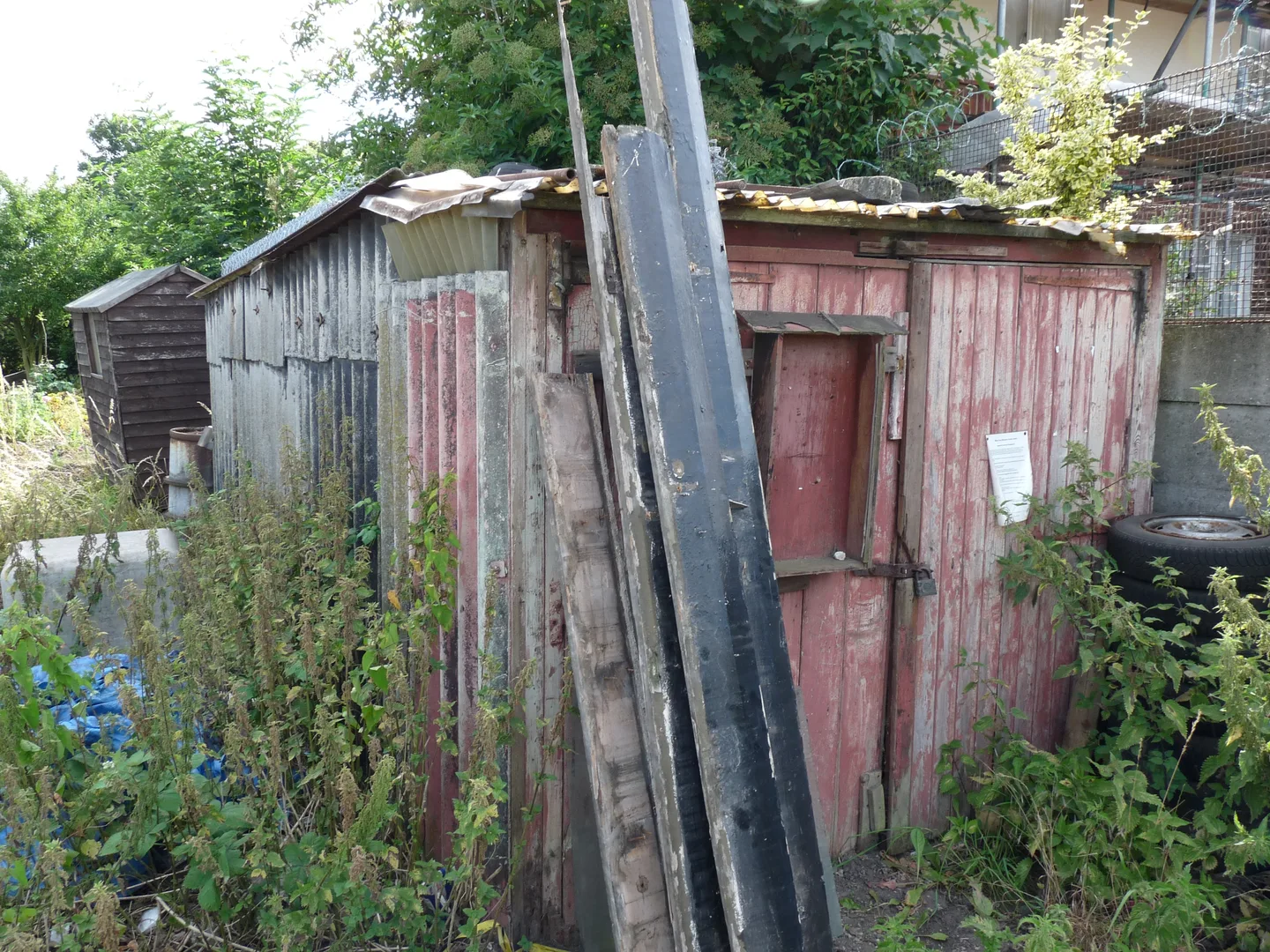 Weathered asbestos-cement outbuilding in a generic shed reference photograph